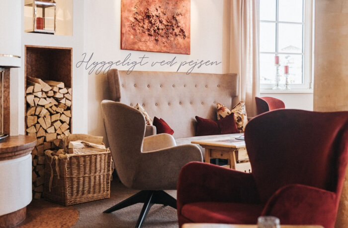 Hyggelig lounge med pejs, kunst og alpin atmosfære på Hotel Schneider i Obertauern